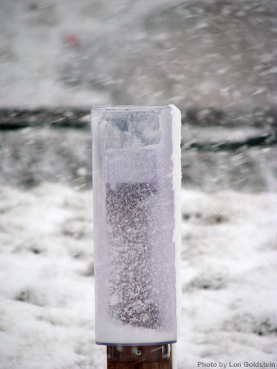 Photo of snow blowing around rain gauge